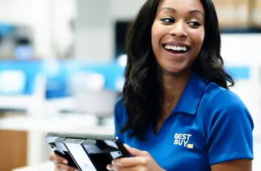 Female Best Buy employee holding a work tool