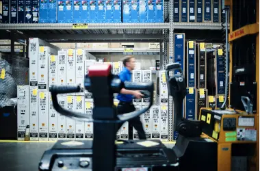 Male Best Buy employee walking through warehouse